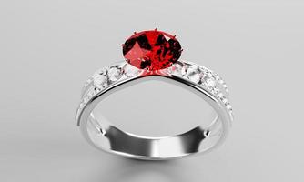 el gran diamante rojo o rubí está rodeado de muchos diamantes en el anillo de oro platino colocado sobre un fondo gris. Elegante anillo de bodas con diamantes para mujer. representación 3d foto