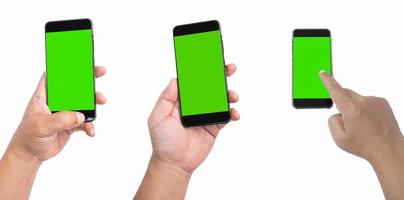 A black smartphone with a green screen is held in the left hand. Place your phone on a white background and poke your index finger on the screen. photo