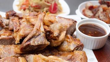 Roasted duck, salt, crispy skin. Crispy golden crispy duck like fried food to dry. Grilled or Baked Chicken for eating with Papaya Salad, sticky rice, a popular lunch among Northeastern Thai people. photo