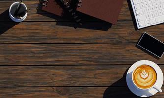 The office desk has items such as keyboards, books, Latte art coffee mugs, and smartphones. The Notebook is made of gray imitation leather. Punched leather book cover on the spine. 3D Rendering photo