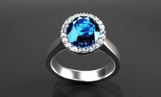 el gran diamante azul ovalado está rodeado por muchos diamantes en el anillo de oro platino colocado sobre un fondo gris. representación 3d foto