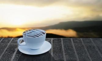 café con leche, espuma de leche cubierta con salsa de chocolate en una taza blanca en la mesa de listones el fondo es una imagen de montaña borrosa. por la mañana y el sol. representación 3d foto