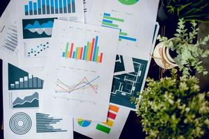 Business desk with business notebook, graph paper, pen on desk, top view with copy space. photo