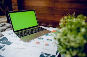 Business desk with business notebook, desk, pen, paper, table graph, top view with copy space photo