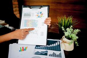 Businessman working at a computer office And graphs on his desk. Business ideas and space for copy. photo