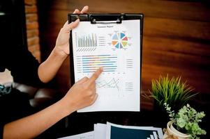 Businessman working at a computer office And graphs on his desk. Business ideas and space for copy. photo