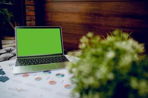 A desk with a business notebook, chart and table top. Top view with copy space photo