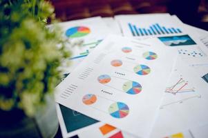 A desk with a business notebook, chart and table top. Top view with copy space photo