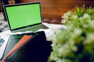 Business desk with business notebook, desk, pen, paper, table graph, top view with copy space photo