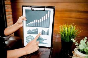 Businessman working at a computer office And graphs on his desk. Business ideas and space for copy. photo