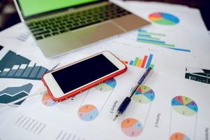 Business desk with business notebook, desk, pen, paper, table graph, top view with copy space photo