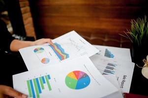 Businessman working at a computer office And graphs on his desk. Business ideas and space for copy. photo