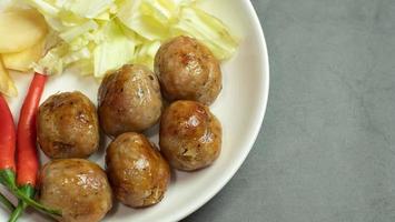 Isan sausage is a name for food that is an appetizer with alcoholic beverages or snacks that are popular in Thailand. Served with fresh old ginger, fresh chilli and cabbage. photo