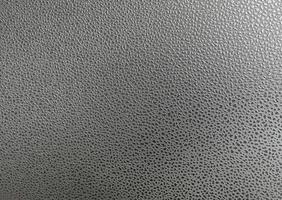 Pattern polka dots on artificial leather surface. There is light shining from the top corner. photo