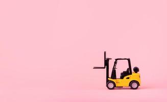 Logistics, and delivery service - Forklift model on Pink background. Shopping service on The online web and offers home delivery. with copy space photo