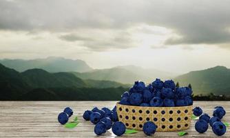 Bulk blueberries in bamboo baskets. Dark blueberry, fresh color, white pattern Falling on a wooden table There are mountain scenery and morning sun as wallpaper or background. Fruit for healthy photo