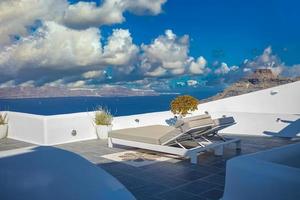 Captivating panoramic caldera view with loungers or sun beds over blue sea bay with cruise ships. Luxury Europe travel, vacation landscape with white architecture. Amazing summer background view photo