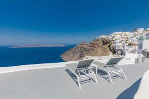 Captivating panoramic caldera view with loungers or sun beds over blue sea bay with cruise ships. Luxury Europe travel, vacation landscape with white architecture. Amazing summer background view photo