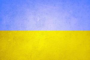 The texture wall is tinted with the yellow-blue flag of Ukraine. Ukrainian national symbols background photo