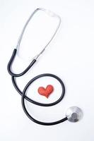Red heart with medical stethoscope. Insurance health or heart treatment, mental health concept. Flat lay vertical format