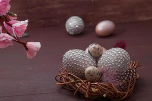 Happy Easter nest with eggs on a wooden background. Happy Easter greeting card with creative easter eggs and copy space photo