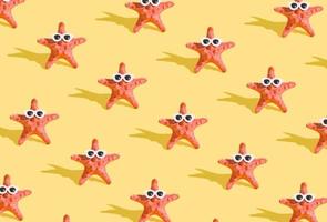 Pattern from starfish in sunglasses on a yellow background. Minimalistic humorous summer background photo