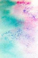 Pink-green watercolor stains with sparkles. Abstract background photo