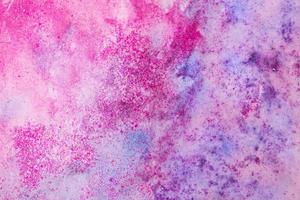 Purple watercolor stains with glitter sequins. Abstract background photo