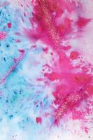 Blue-pink watercolor stains with glitter sequins. Abstract background photo