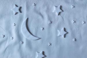 Flat lay composition of the moon and stars on the sheet. Dream creative concept photo