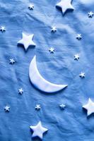 Flat lay composition of the moon and stars on the sheet. Dream creative concept photo