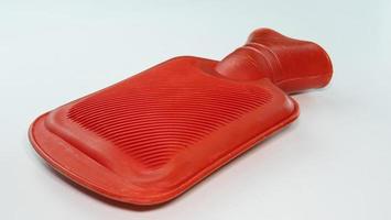 Red hot water bag for compressing Relieve muscle injuries or keep warm. Place it on a white background. A device for holding hot water. To compress before physical therapy.
