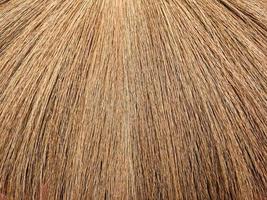 Textures or stripes from the tip of a brown grass broom for use as a background or wallpaper photo