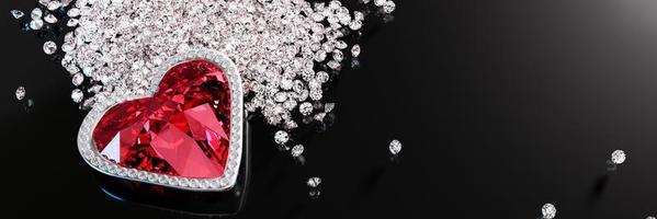 A red diamond or a large ruby in the shape of a heart, a symbol of love or Valentine's Day. A red diamond is placed on a pile of small diamonds. On the black reflection. 3D Rendering. photo