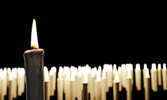 White candles and flames. Many lit candles are blurred into background. 3d Rendering photo