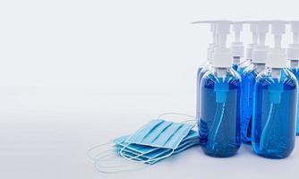 Medical protective mask and  Alcohol gel sanitizer hand gel cleaners for anti Bacteria and virus on White Background. People using alcohol gel to wash hands to prevent COVID-19. 3D Rendering. photo