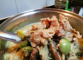 Rice noodles in green curry with beef. Traditional Thai food consisting of beef, eggplant, eggplant, basil leaves, and curry paste photo