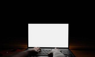 The hand of a person using a notebook or laptop, a blank screen, white, dark background, blacklight shines down on the hand. Mystery operation or hacker.3D Rendering photo