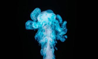 humo blanco mezclado con flotadores azules de abajo hacia arriba sobre un fondo negro.representación 3d foto