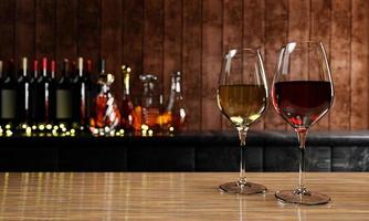 Red and white wine in clear glass, many blurred wine , whisky and brandy bottle backgrounds Place it on a wooden and mable floor with a wooden board wall. The cellar Tasting production concept.