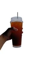 Iced lemon tea in a glass on a man hand photo