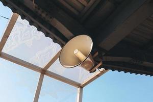 White loudspeakers under the roof of building photo