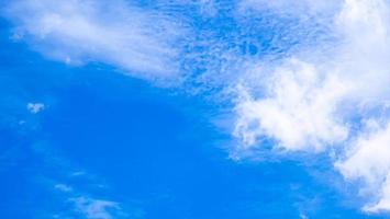 Blue sky and white cloud use for background. The sky is bright blue with white clouds scattered. Nature images with sky and clouds, perfect for use as wallpaper, banner or background. photo