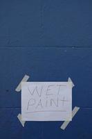 Wet Pain paper sign on blue wall photo