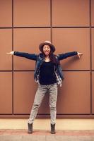 emotional girl stands near a wall photo