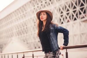 sensual portrait of a lady in a hat in the city photo