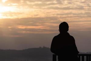 Silhouette of traveller man photographer with morning sunrise. photo