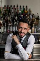 Handsome barkeeper working at counter photo