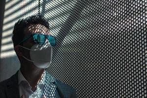 Modern businessman in protective mask and sunglasses photo