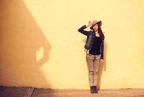 bright stylish pretty brunette posing in hat photo